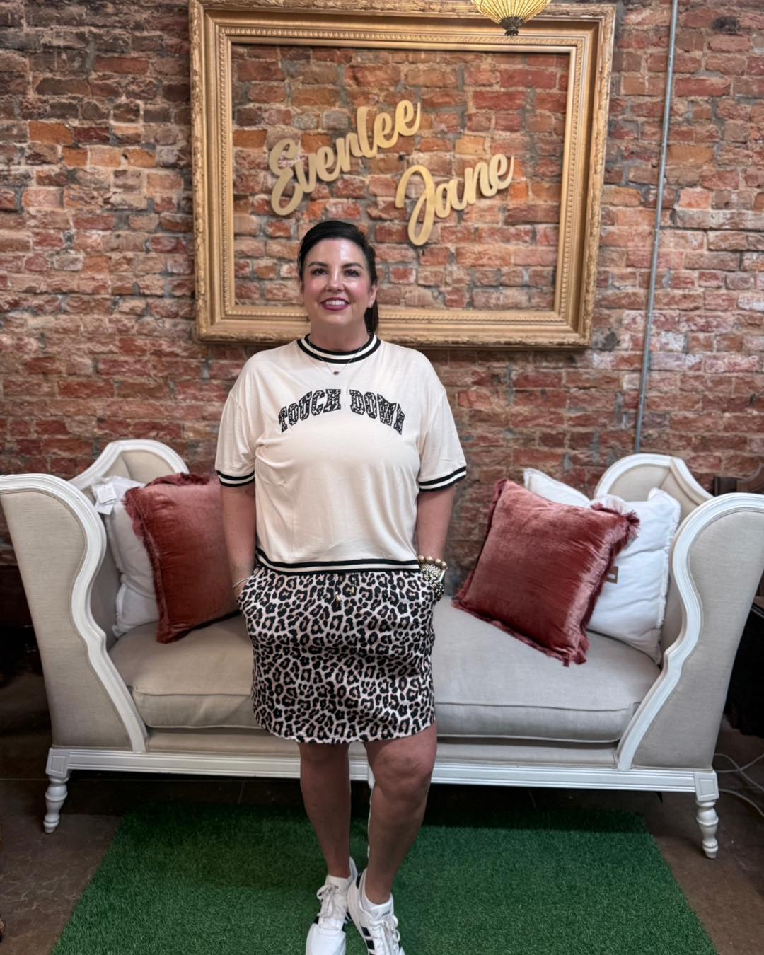 Touch Down Leopard Tee with leopard print design, available in sizes S-XL.