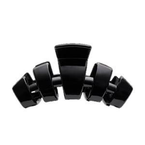 The TELETIES Classic Hair Clip is a glossy black, abstract sculpture-inspired accessory featuring intersecting rectangular and curved shapes. Available in a variety of seasonal styles.