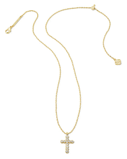 14k yellow gold Cross Pendant Necklace in White Crystal by Kendra Scott, with a diamond-studded cross pendant and delicate round charm near the clasp. Available in lengths 16″, 18″, and 20″.