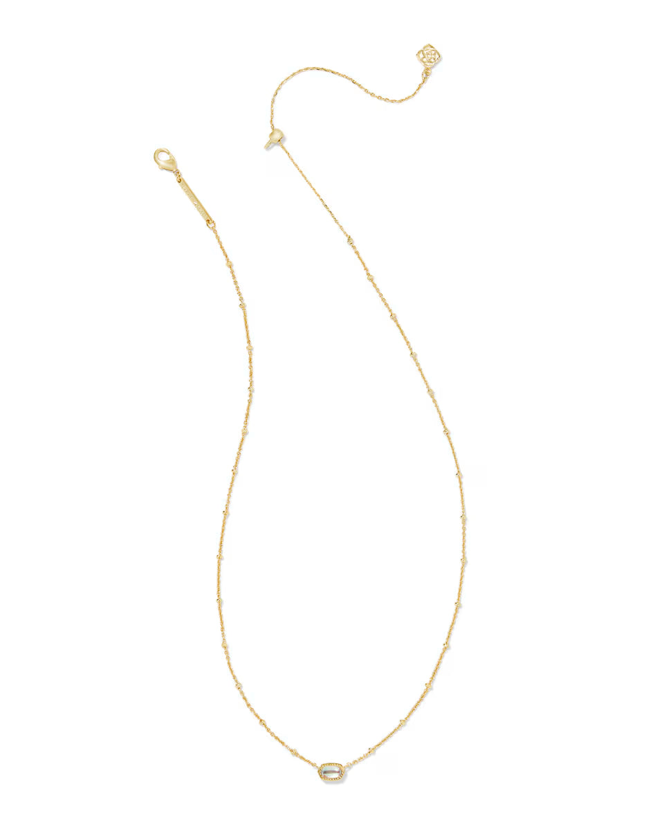 Mini Elisa Gold Satellite Short Pendant Necklace by Kendra Scott with a delicate gold chain, adjustable clasp, and small oval dichroic glass pendant. Available in one size.