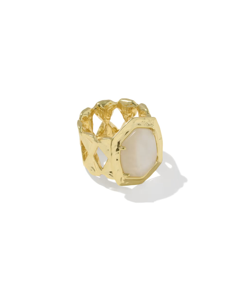 Gold cocktail ring with an open lattice-inspired band, hammered texture, and a central polished natural mother-of-pearl stone in a geometric gold rim. Available in sizes 5-9.