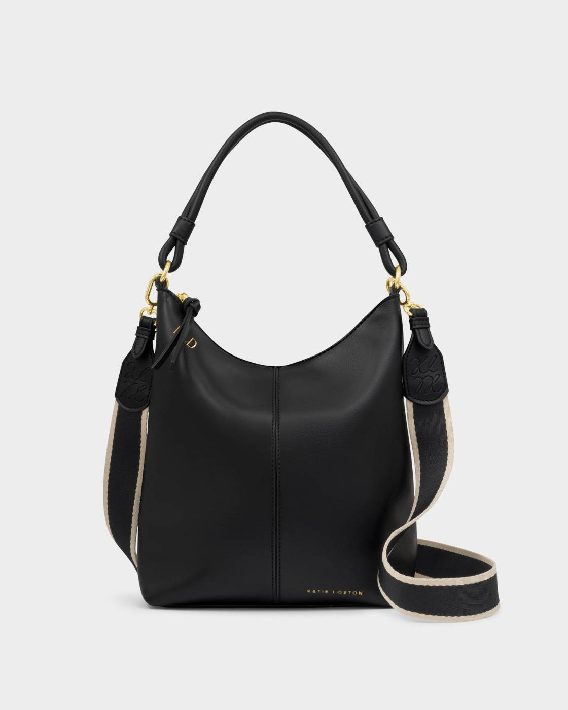 The Hallie Satchel Bag | Black is a chic shoulder bag made from supple vegan leather with gold hardware, a short handle, and a detachable black and beige striped shoulder strap. Sizes available: Small, Medium, Large.