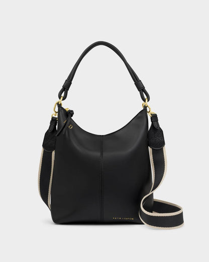 The Hallie Satchel Bag | Black is a chic shoulder bag made from supple vegan leather with gold hardware, a short handle, and a detachable black and beige striped shoulder strap. Sizes available: Small, Medium, Large.