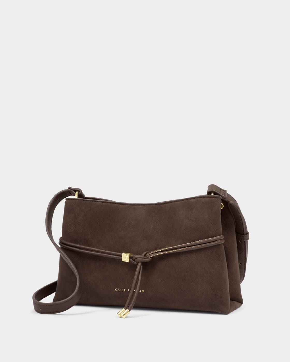 Bitter Chocolate Lori Suedette Crossbody Bag with gold accent knot and adjustable strap. Available in small, medium, and large sizes.