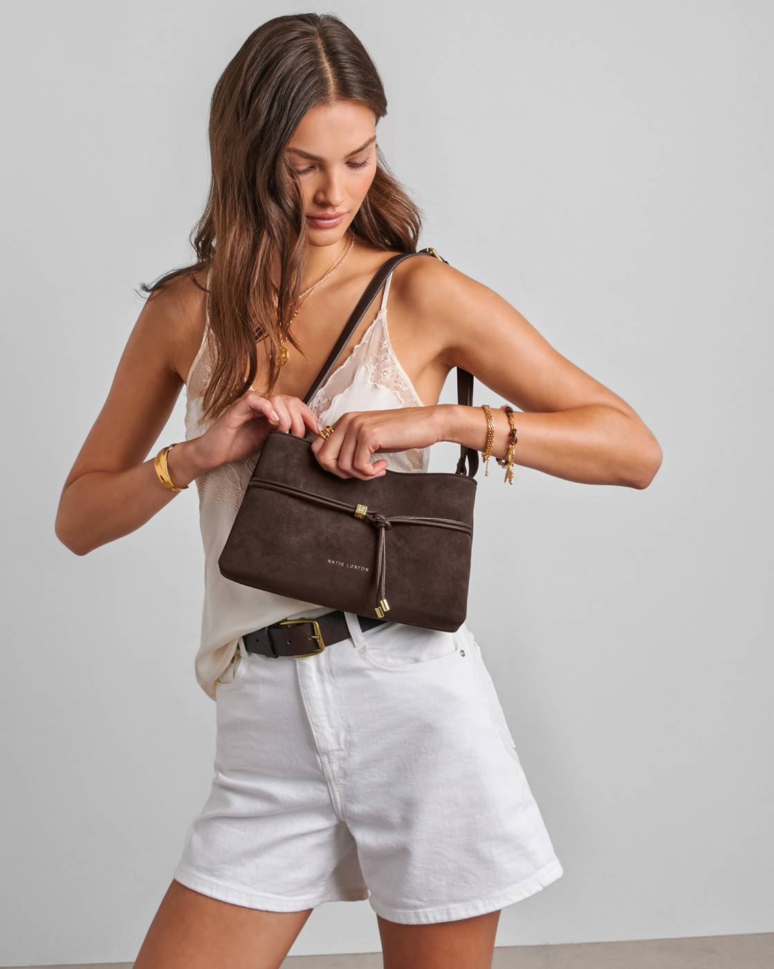 Lori Suedette Crossbody Bag in Bitter Chocolate with adjustable strap, available in small and medium sizes.