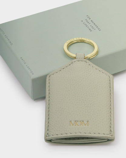Pale green vegan leather keyring embossed with "MOM" in gold. Includes sage green gift box. Sizes available: standard only.