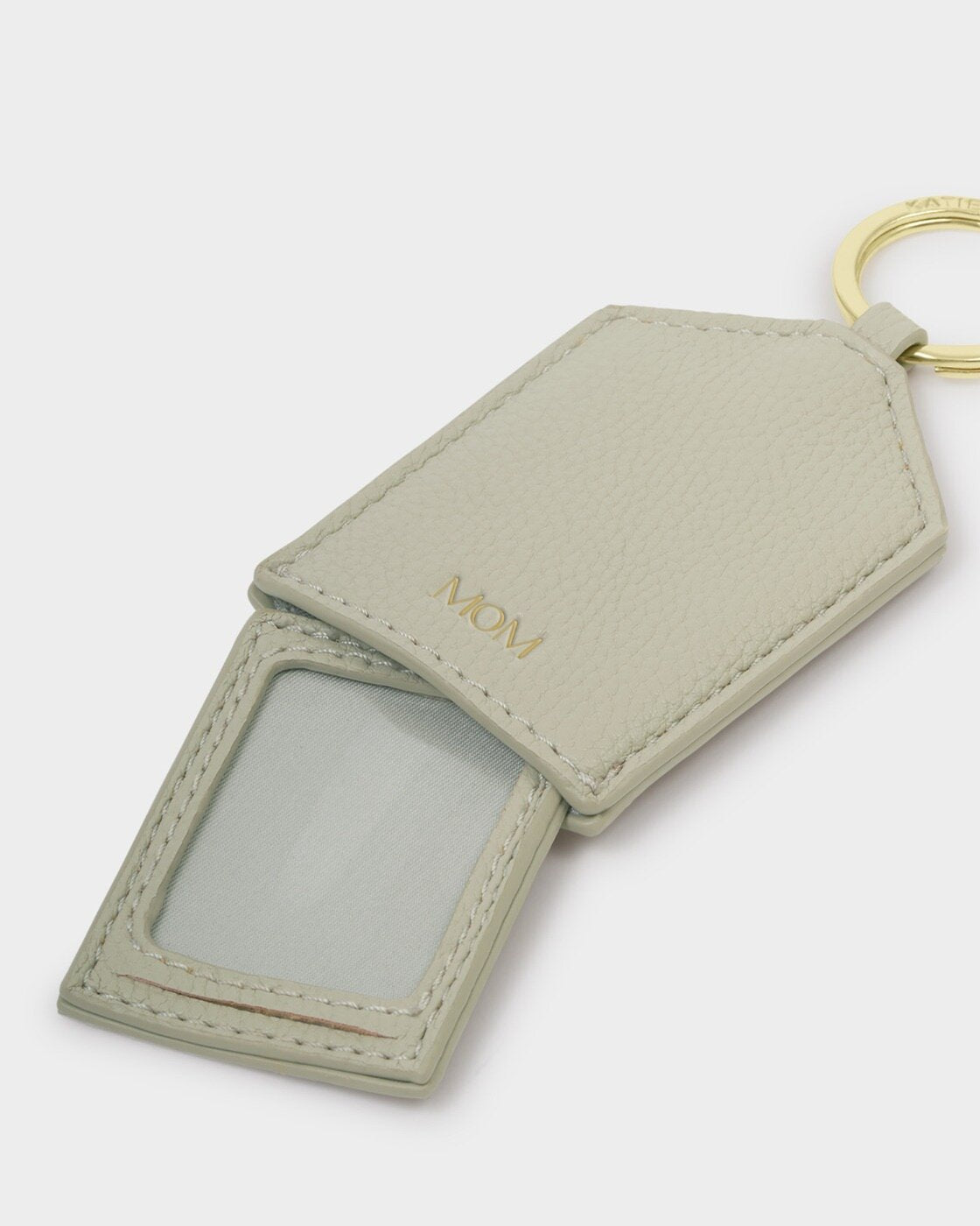 Green vegan leather keyring with gold ring, photo/ID window, “MOM” in gold, protective cover. Size: standard keyring.