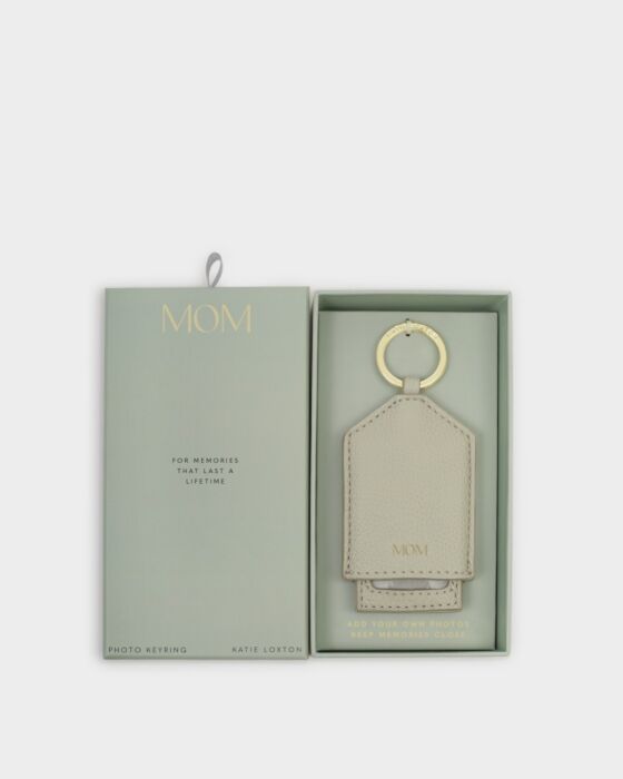 Beige vegan leather keyring with "MOM" in gold, pastel green box. Hidden photo slot. Size: standard keyring.