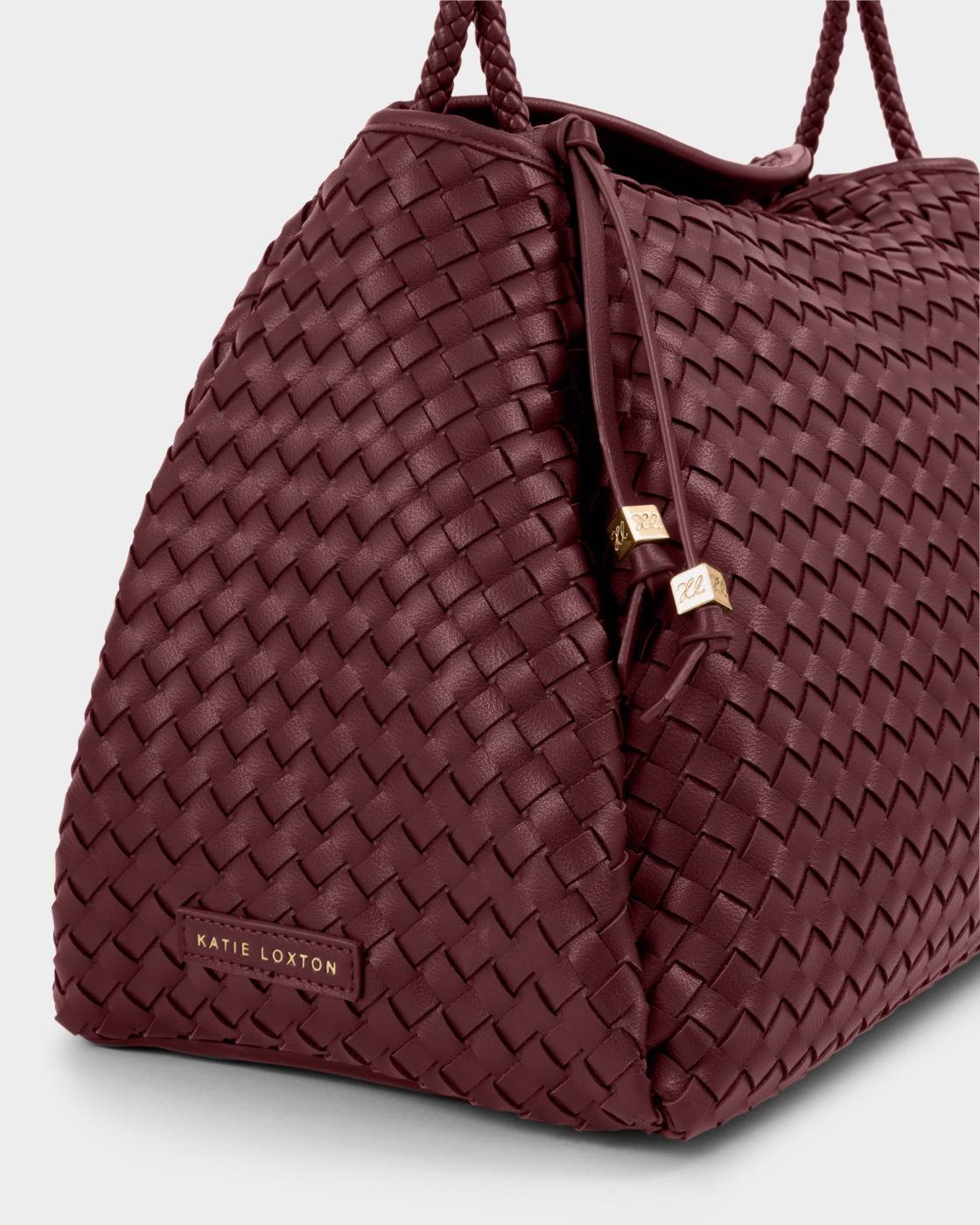 Nova Hand Woven Large Shoulder Bag in Cherry, burgundy vegan leather with gold drawstring accents and small metal “Katie Loxton” label; available in large size.