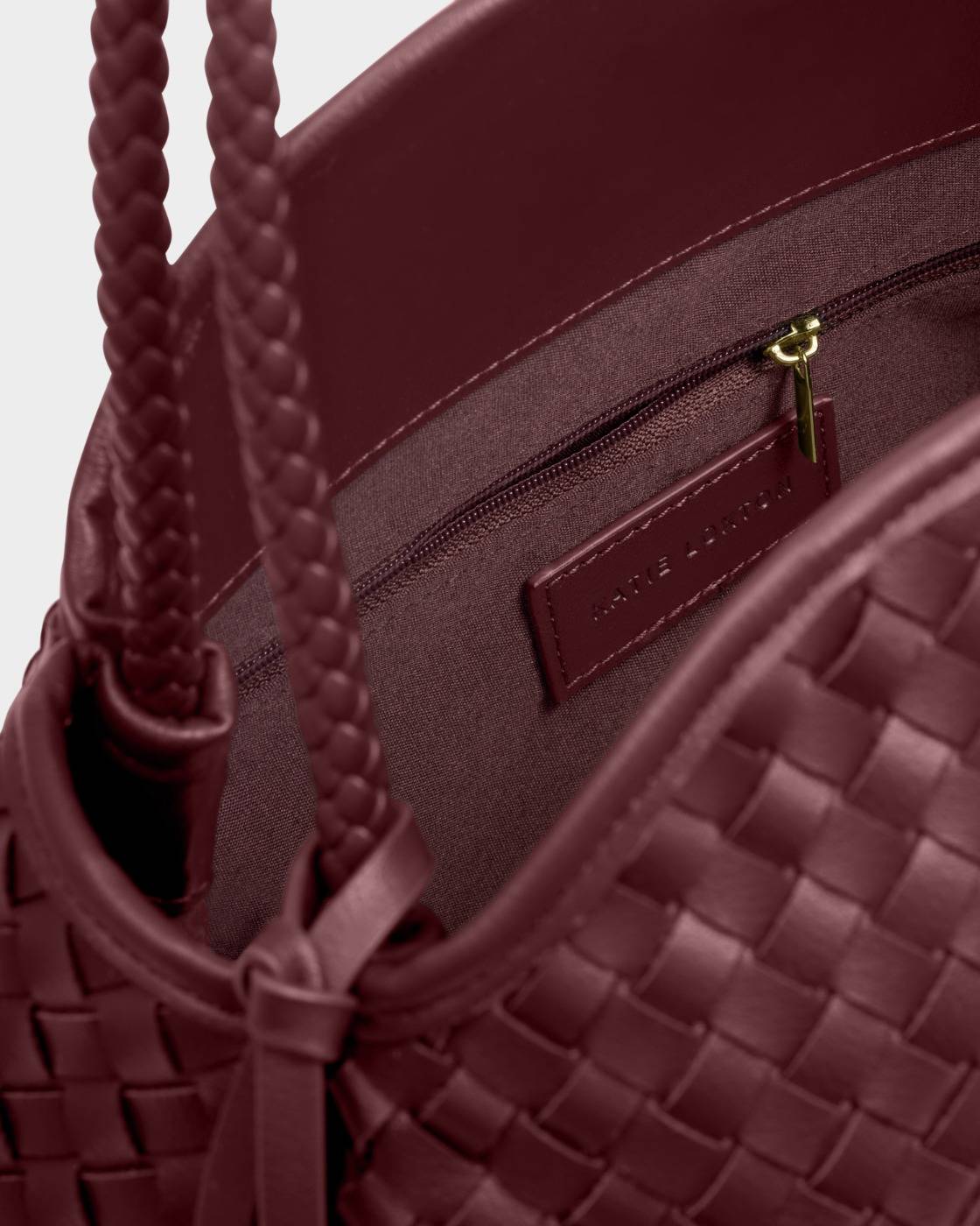 Nova Hand Woven Large Shoulder Bag in Cherry with braided vegan leather handles, interior zippered pocket, and branded leather tag. Available in large size.