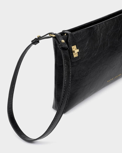 The Orin Twist Lock Small Shoulder Bag is made of black vegan leather with a wrist strap, gold-tone hardware, and a small gold “Kate Spade” logo. Versatile for use as a clutch or small shoulder bag, it has an elegant twist lock closure. Sizes available: small.