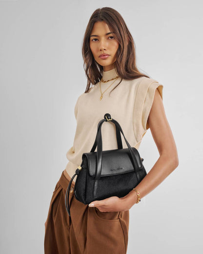 Alyssa Faux Pony Top Handle Bag in black, sleek design with optional crossbody strap, available in small and medium sizes.