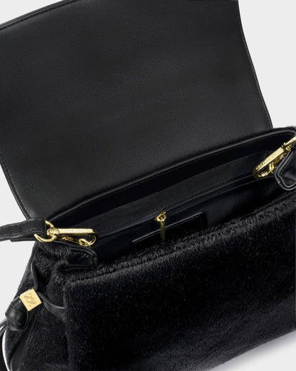 Alyssa Faux Pony Top Handle Bag in black with gold zipper and hardware. Suede-like vegan leather exterior, leather interior, spacious main compartment, zippered pocket, and crossbody strap. Sizes available: Small, Medium.