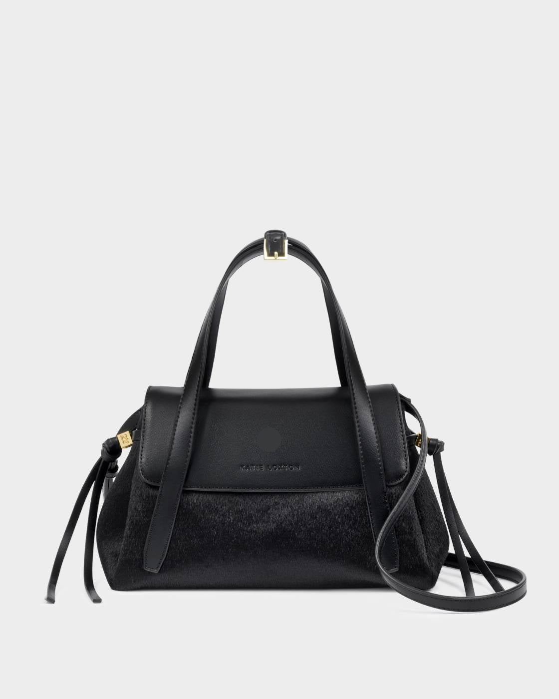 Alyssa Faux Pony Top Handle Bag in black faux pony hair and leather with gold hardware, top handle, detachable crossbody strap, flap closure, and side tassel details. Sizes available: [insert sizes].
