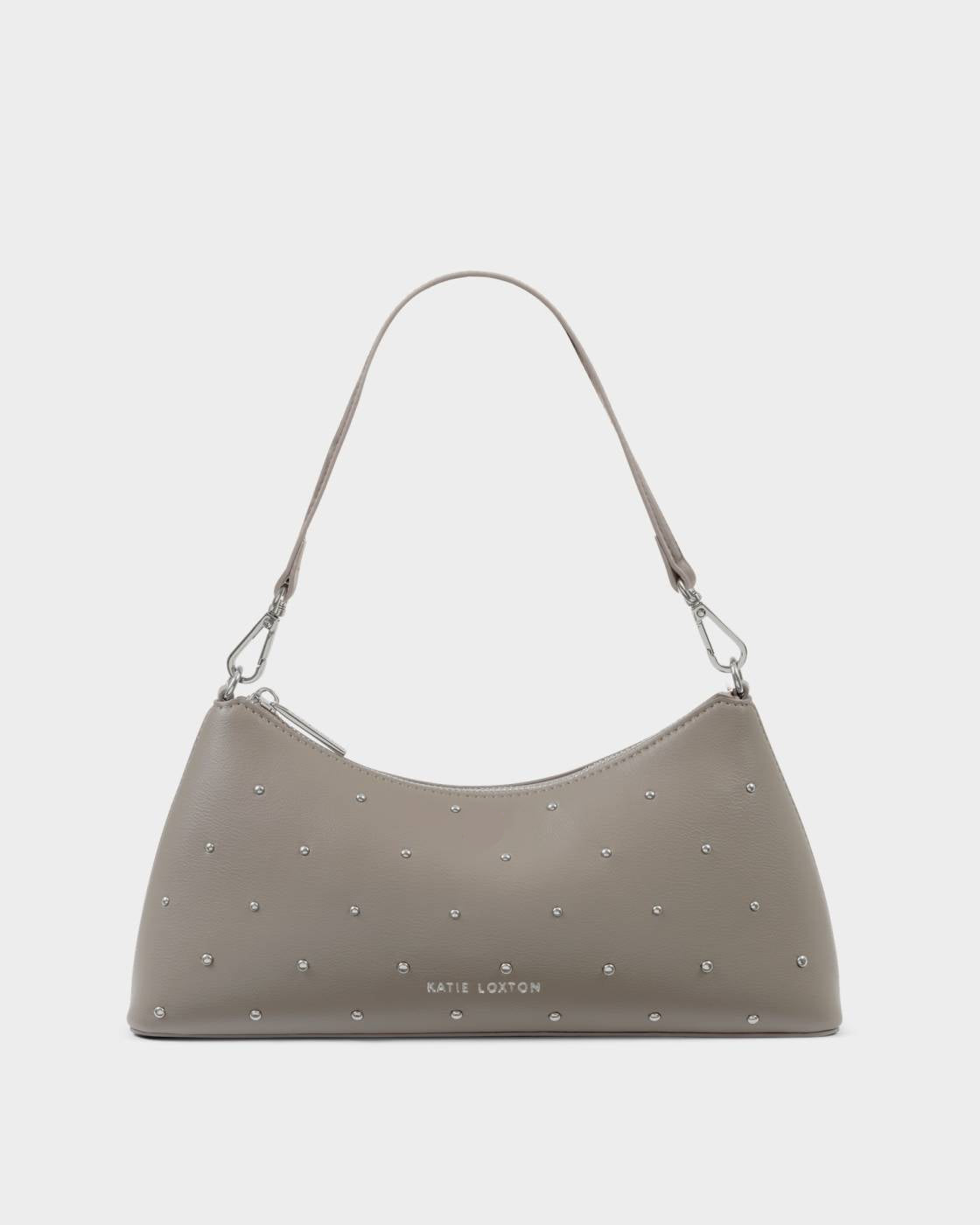 The Miley Studded Small Shoulder Bag in Silver Mink features studded vegan leather, a single shoulder strap, silver hardware, small silver studs, and the embossed “Katie Loxton” logo on the front; available in a small size.