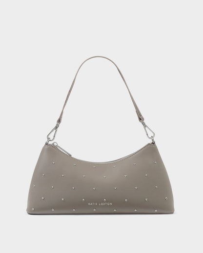 The Miley Studded Small Shoulder Bag in Silver Mink features studded vegan leather, a single shoulder strap, silver hardware, small silver studs, and the embossed “Katie Loxton” logo on the front; available in a small size.