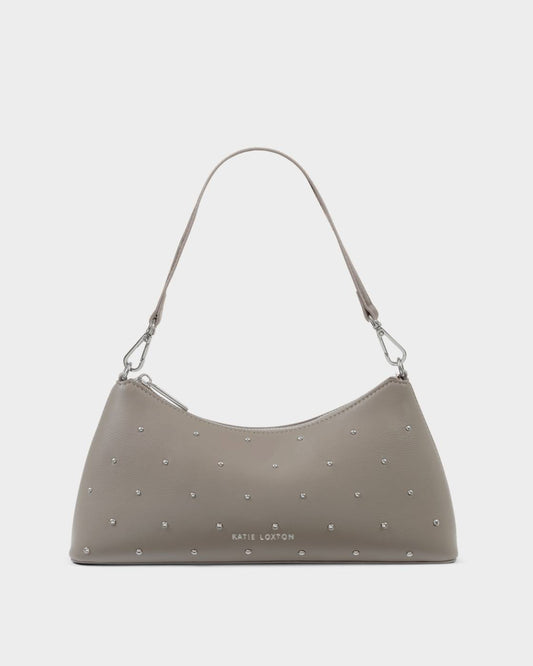 The Miley Studded Small Shoulder Bag in Silver Mink features studded vegan leather, a single shoulder strap, silver hardware, small silver studs, and the embossed “Katie Loxton” logo on the front; available in a small size.