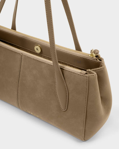 Hattie Suedette Shoulder Bag in taupe vegan suede with two handles, magnetic snap closure, gold zipper, prominent stitching, and side pocket. Available in one size.