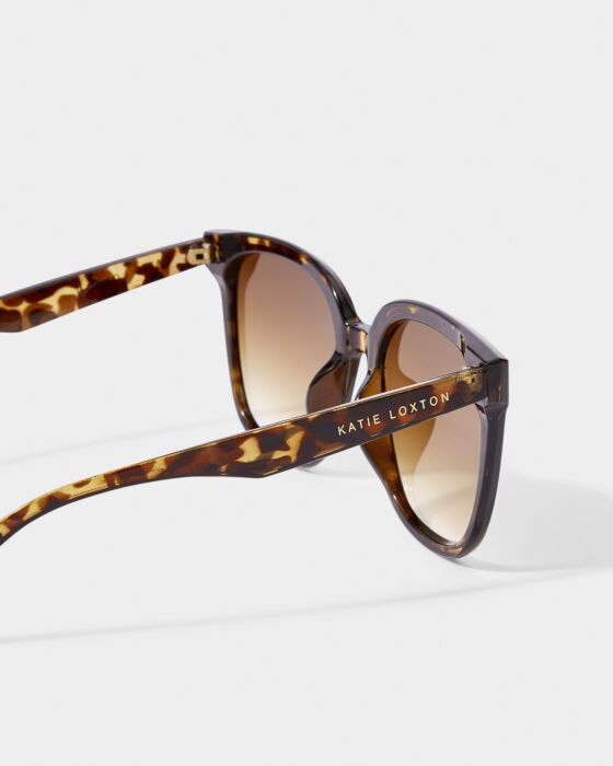Savannah Sunglasses: brown tortoiseshell, gradient brown lenses, UV400, “Katie Loxton” in gold on arm. Sizes: S, M, L.