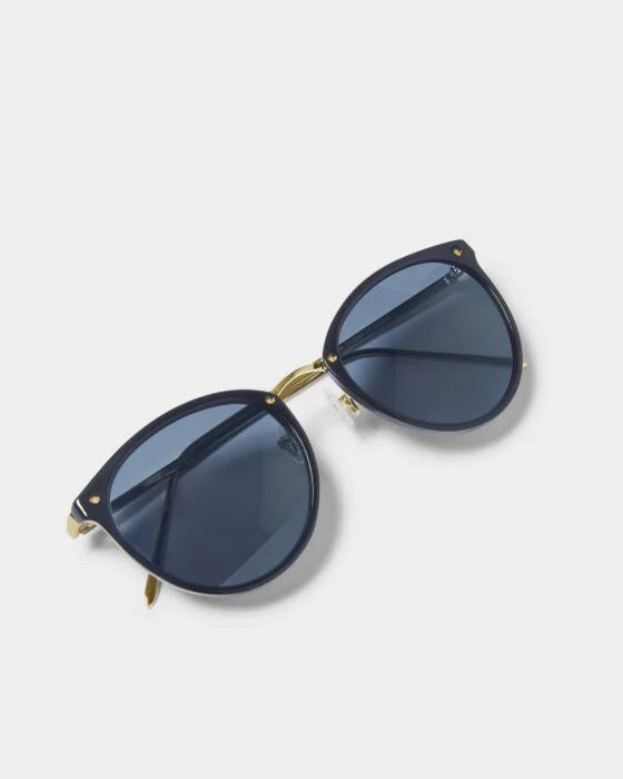 Santorini Sunglasses: navy blue, gold accents, dark lenses, recycled materials, UV400 protection. Sizes S/M/L/XL.