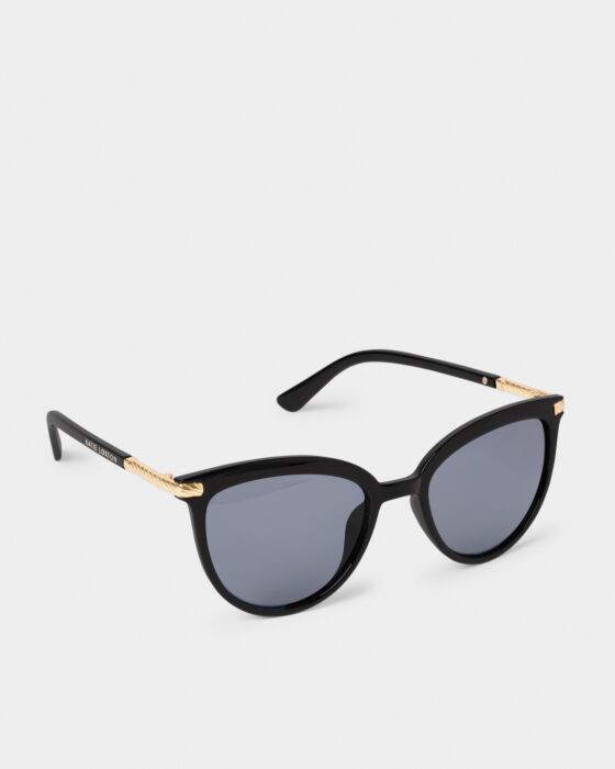 Ravello Sunglasses in black with round frames, dark UV400 lenses, gold arm detail. Available in multiple sizes.