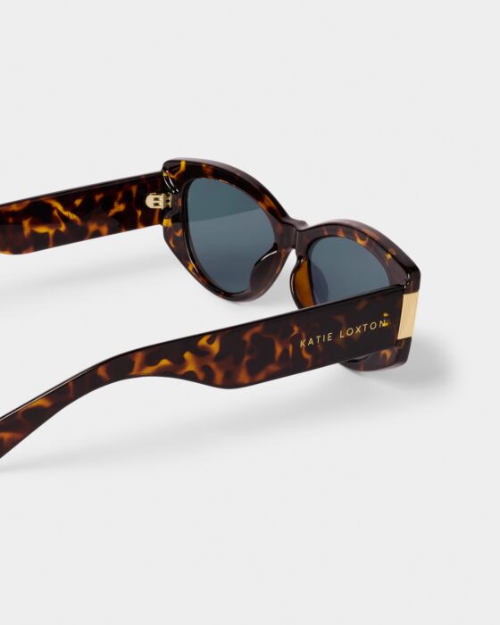 Rimini Cat-Eye Sunglasses in tortoiseshell with dark UV400 lenses, gold accents, "KATIE LOXTON" branding. Sizes: S, M, L.