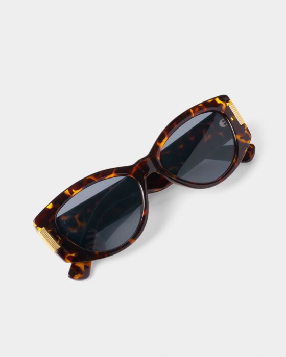 Rimini Cat-Eye Sunglasses in tortoiseshell with dark lenses, gold accents, UV400 protection. Made from recycled materials. Sizes S, M, L.