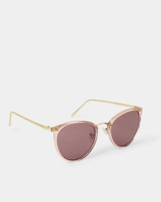 Pink cat-eye sunglasses with gold metal arms, pink UV400 lenses, recycled materials. Sizes: S, M, L, XL.