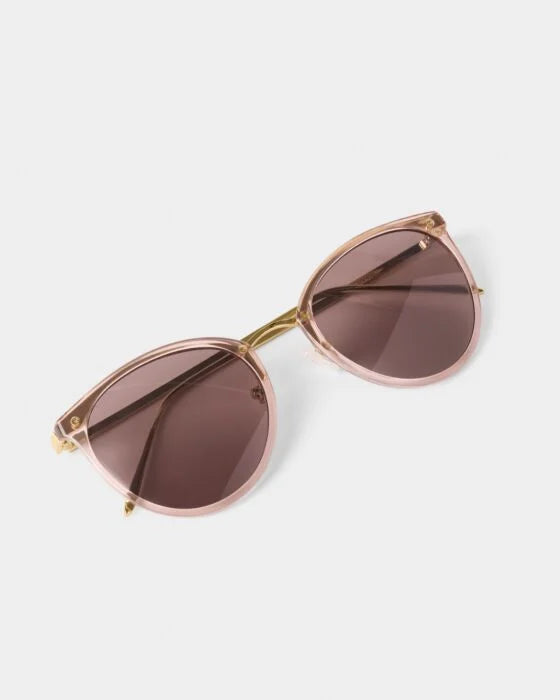 Santorini Sunglasses: cat-eye, light pink translucent acetate, gold accents, UV400, dark lenses. Available in 4 sizes.