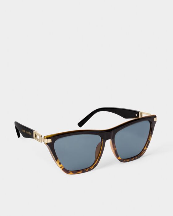Marbella Sunglasses: Tortoiseshell frames, gold accents, blue UV400 lenses, black arms, "Kirk Lovers" in gold. Sizes: S/M/L.