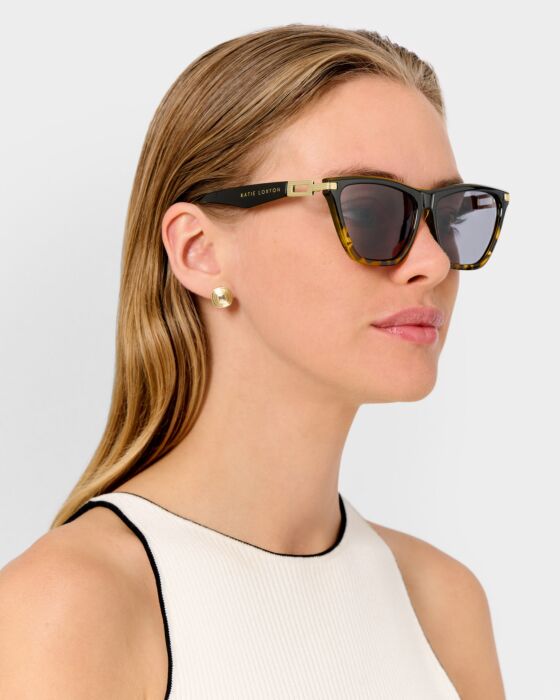 Marbella Sunglasses, available in S, M, and L. Sleek frame design with dark lenses.