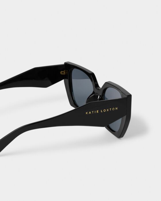 Corsica Sunglasses: thick black frames, gold "KATIE LOXTON" on temple, recycled materials, UV400. Sizes: S, M, L.