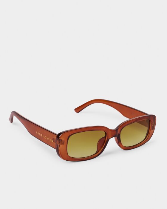 Venice Sunglasses: rectangular brown translucent frames, yellow UV400 lenses, gold "Katie Loxton" logo. Sizes available: one size.