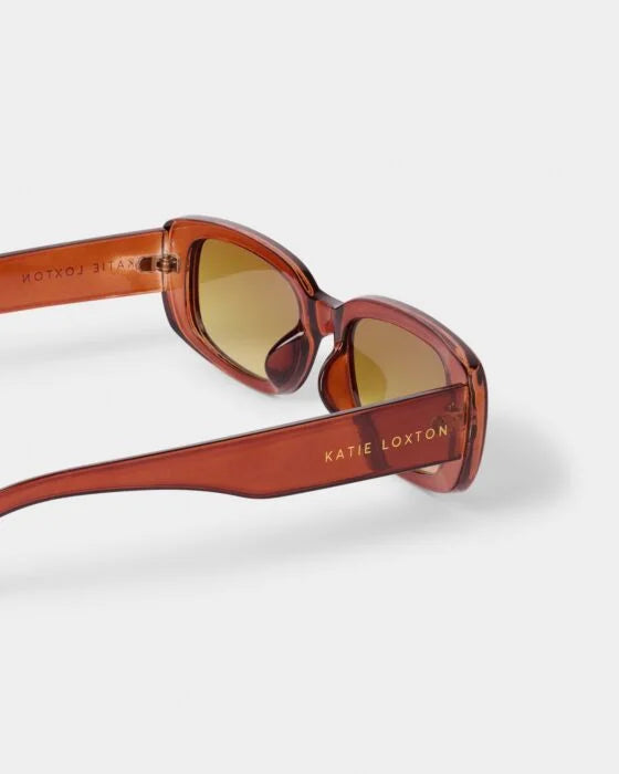 The Venice Sunglasses: thick frames, brown UV400 lenses, "KATIE LOXTON" gold detail, recycled materials. Sizes: S, M, L.