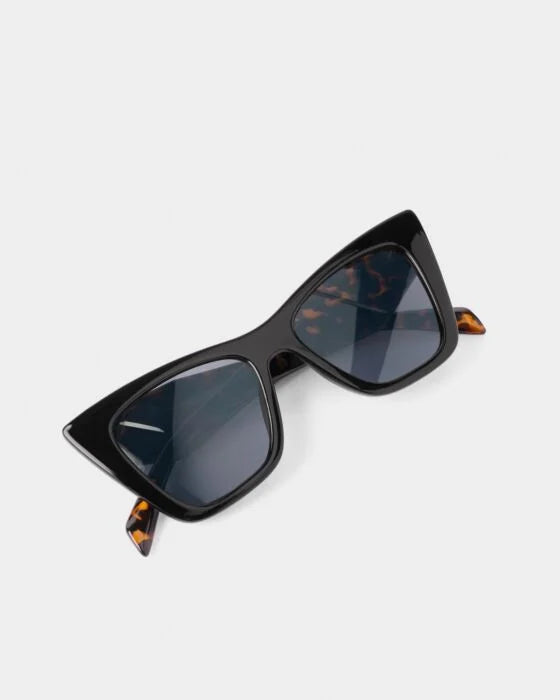 Black Porto Sunglasses with cat-eye frames, UV400 dark lenses, tortoiseshell temple tips. Available in S, M, L.
