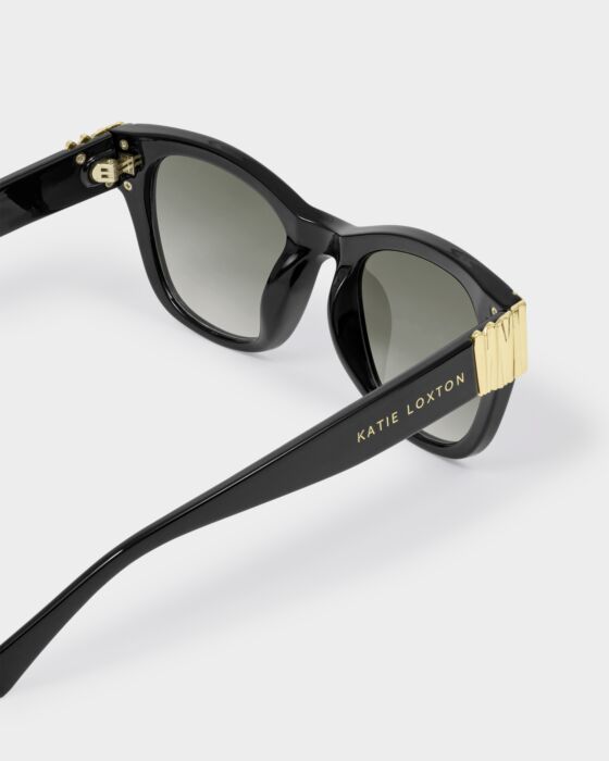 Black round cat-eye sunglasses with gold accents, "KATIE LOXTON" on the side, UV400 lenses. Available in one size.