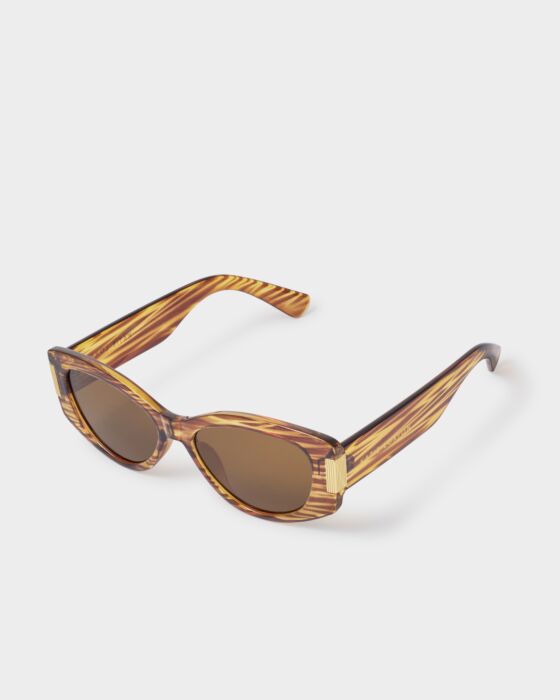 Brown oval cat-eye sunglasses with tiger-print recycled frames and arms. Available in 3 colors and multiple sizes.