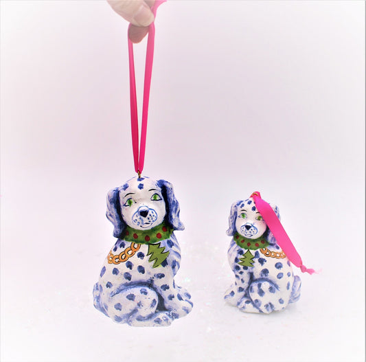 Two 3x5" Paper Pulp Staffordshire Dog Ornaments with blue spots and green collars. One ornament hangs by a pink ribbon, the other sits upright.