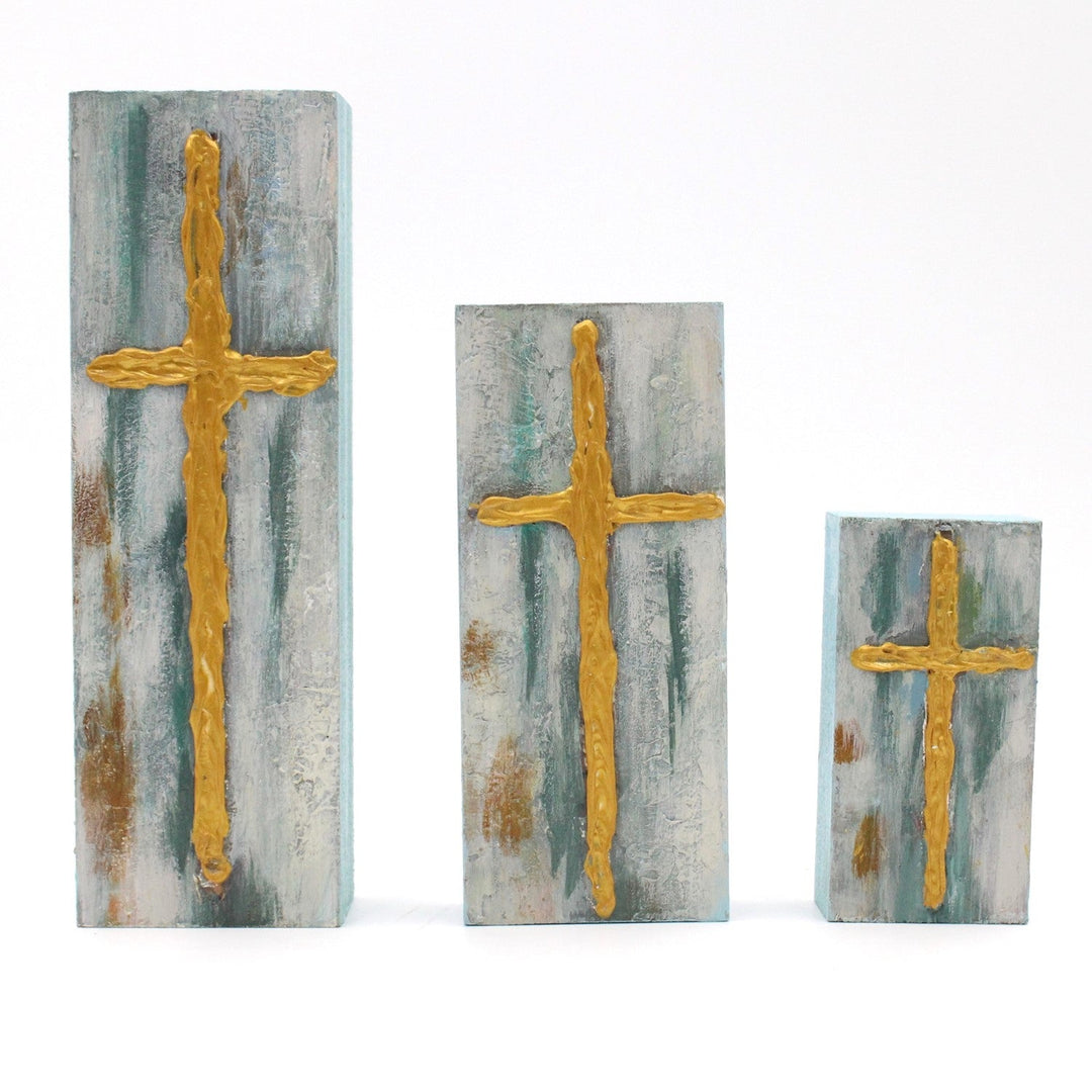 Wood Block with a handpainted gold cross on marbled blue, white, and brown. Available sizes: 4x4", 6x6".