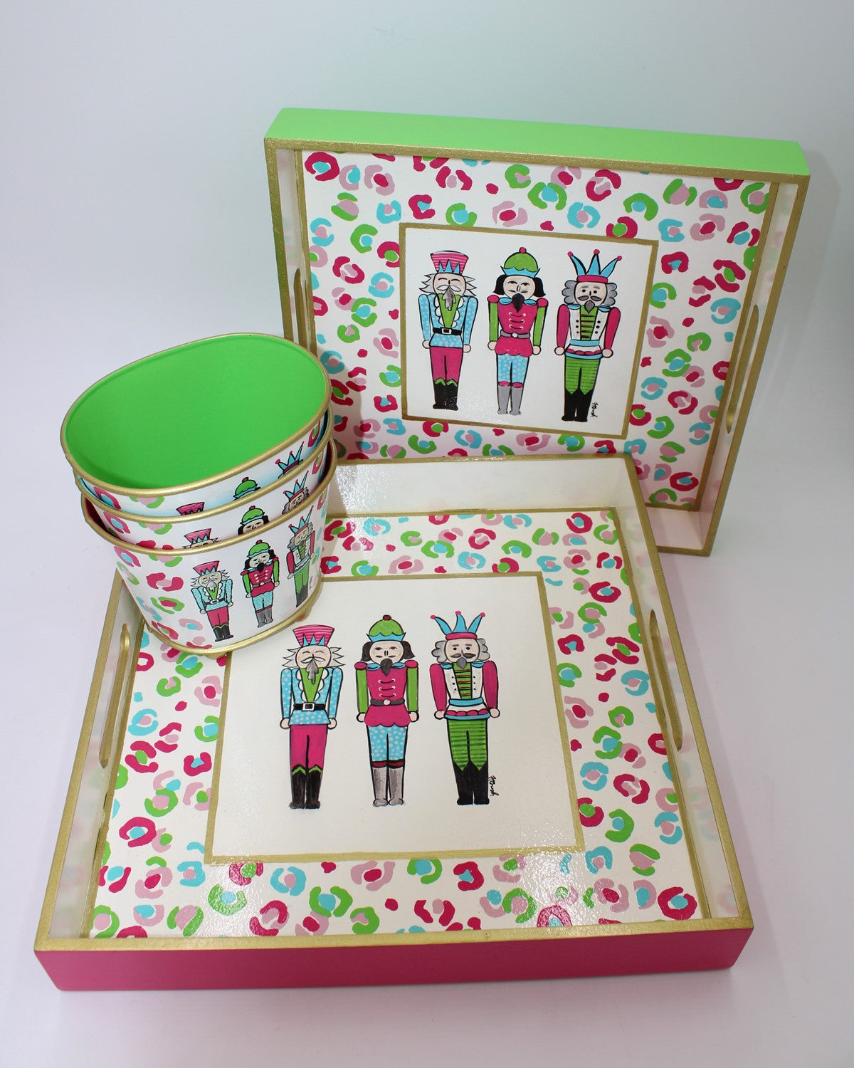 Handpainted Nutcracker Trio Wood Square Trays gift set with vibrant nutcracker designs, includes two square trays with lids and three nested bowls. Size: Various sizes for trays and bowls.