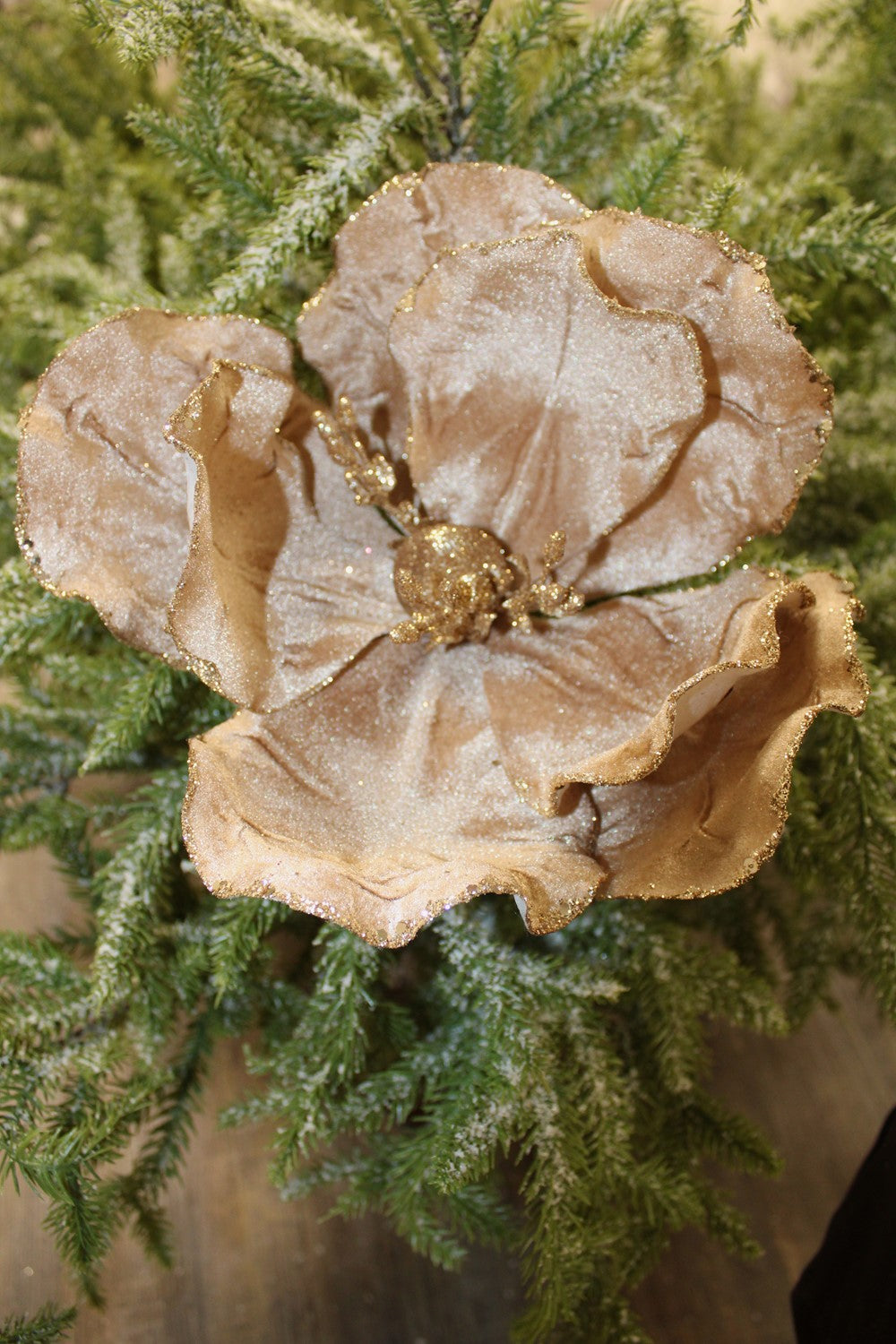 Gold glitter-dusted magnolia stem.