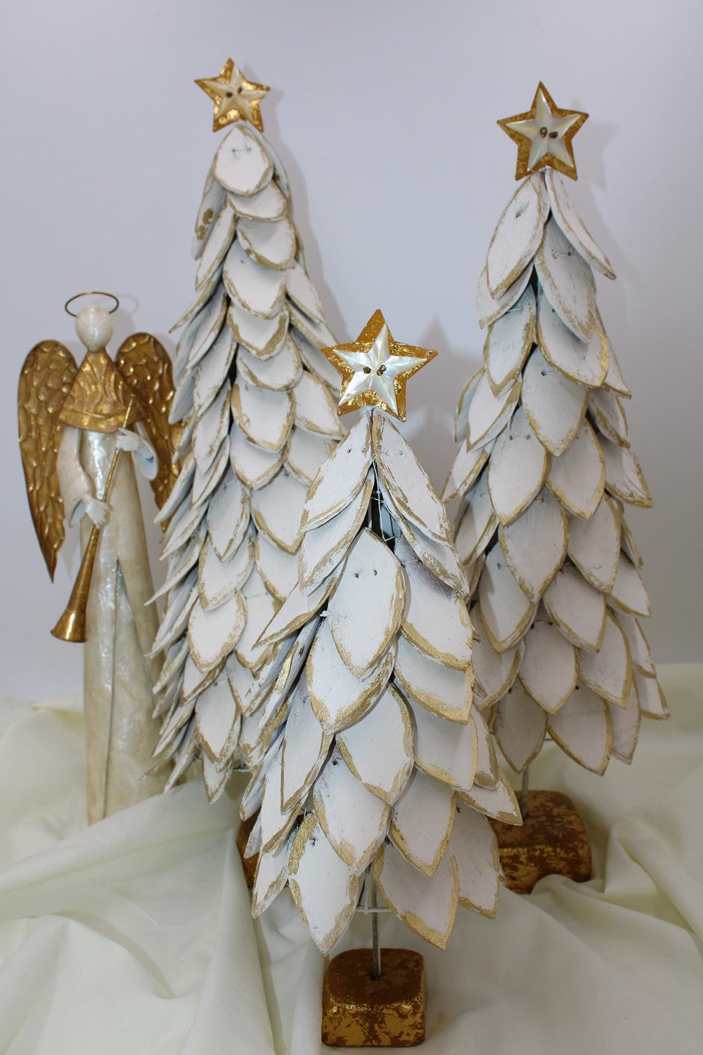 Three white coconut trees with layered leaves, gold trim, and gold star toppers on a gold base. Available in various sizes.