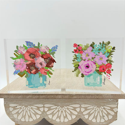 The Flowers in Vase Acrylic Block Sign includes two acrylic flower paintings with a wooden stand. Sizes available: not specified.