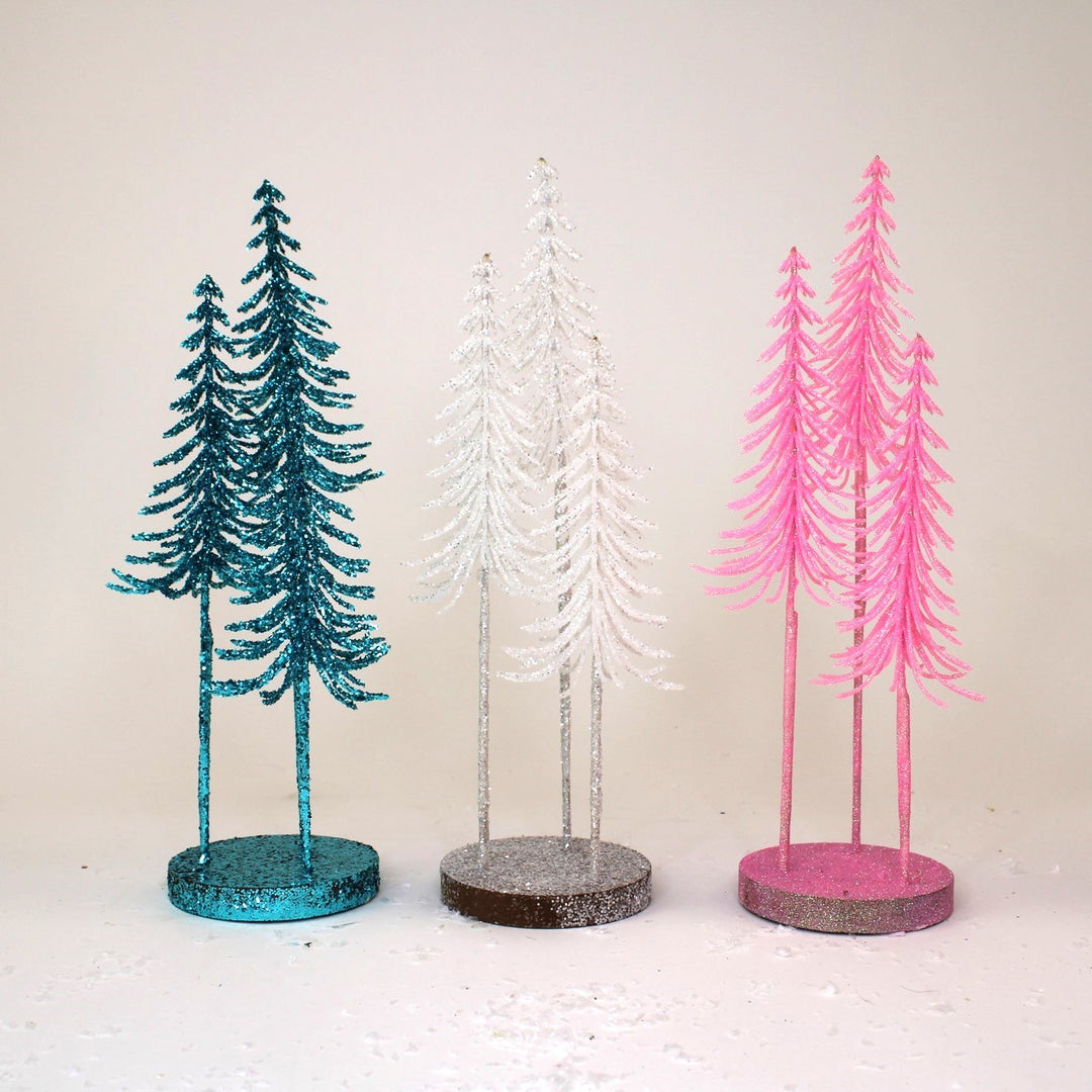 5″x14″ Three glittered trees in blue, white, and pink on circular bases.