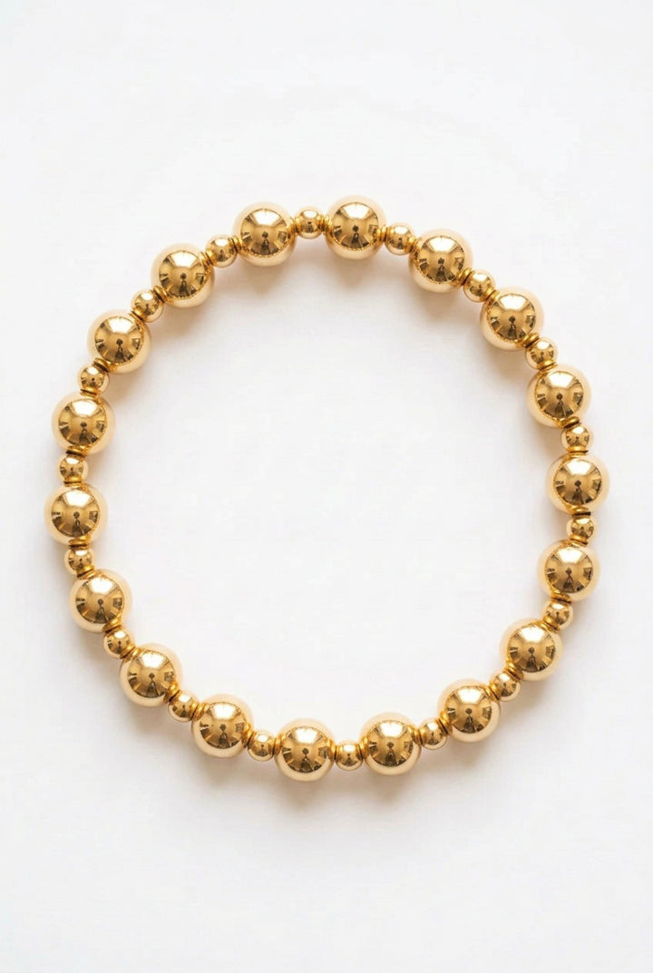 Carrie Water Resistant Stretch Beaded Bracelet with alternating large and 6 mm metallic spherical beads.