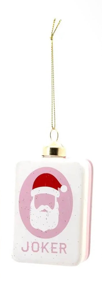 Rectangular Mahjong Christmas ornament with a Santa hat and beard in a pink oval above the word “JOKER,” suspended by a gold cord.
