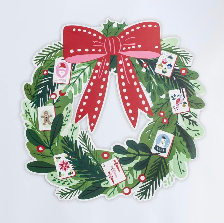 Jingle Pop Flat Metal Wreath with a red bow and Christmas-themed playing card illustrations.