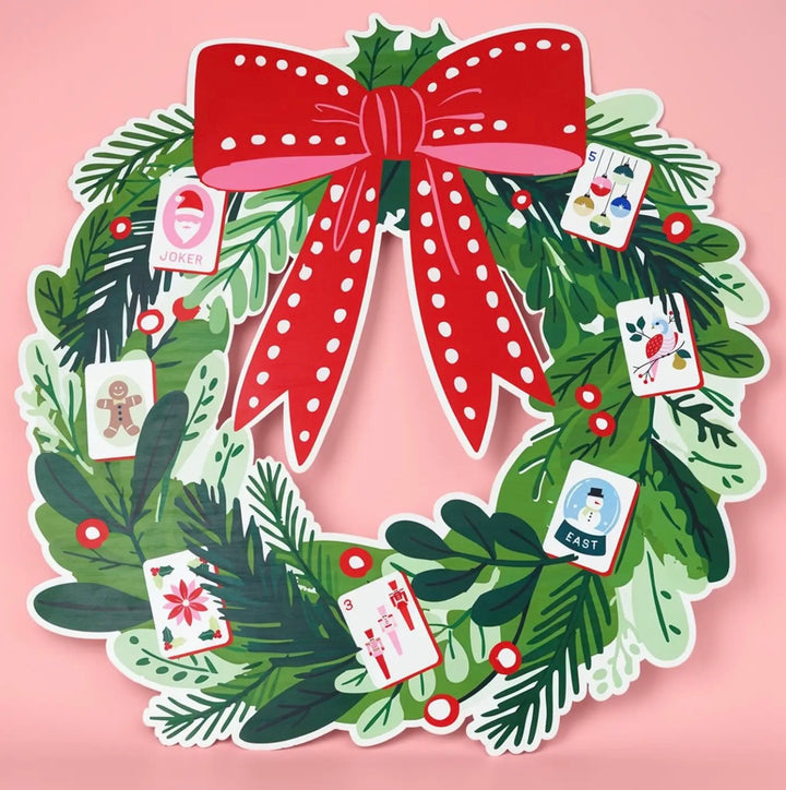 Jingle Pop Flat Metal Wreath with greenery, red polka-dot bow, and holiday playing cards.