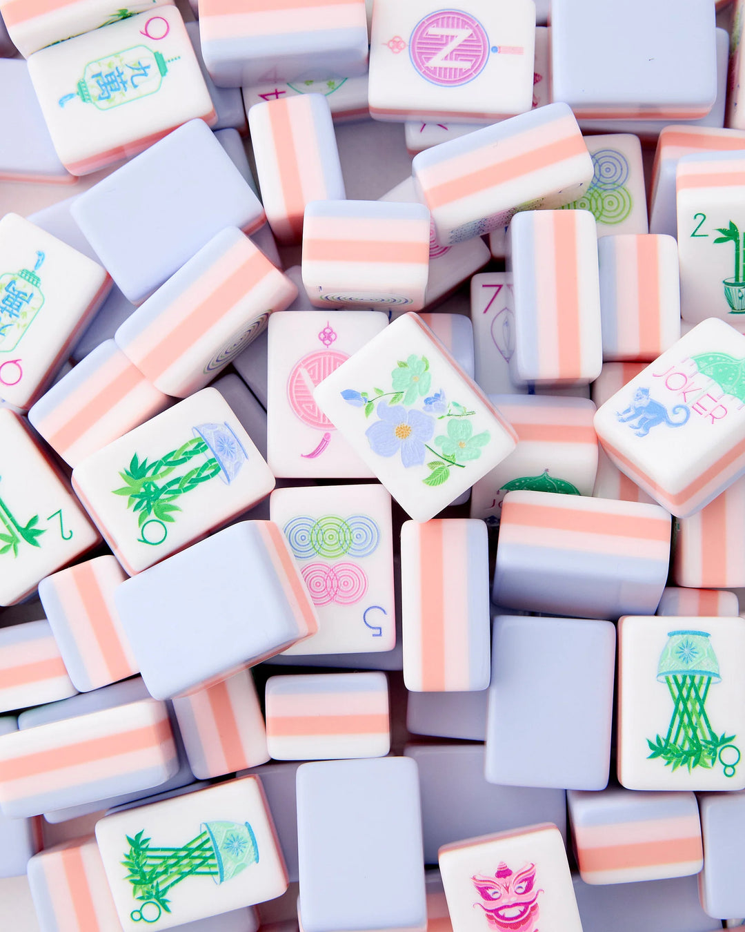 Luminaire Mahjong Tiles: pastel pink, white, and lavender tiles with colorful designs; available in standard and large sizes.