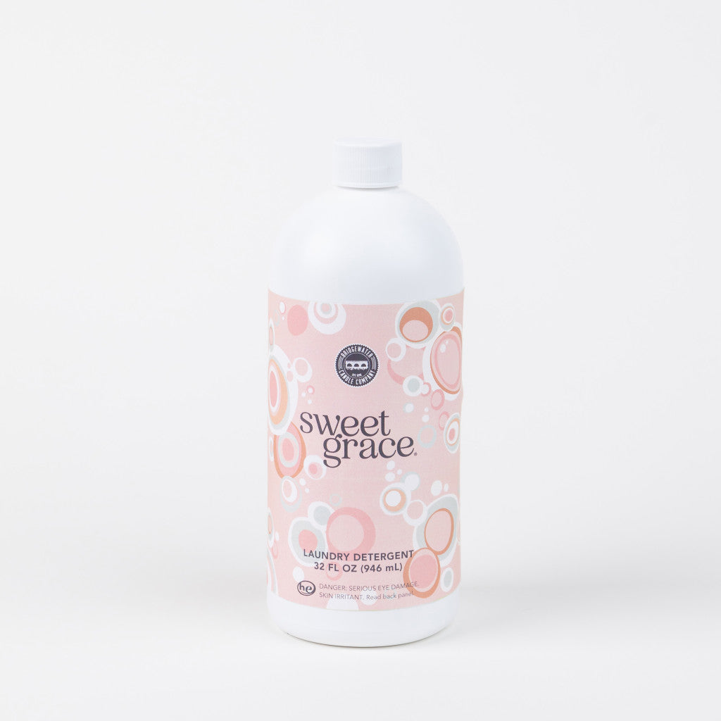 32oz white plastic bottle of Sweet Grace Laundry Detergent with pink bubble label, long-lasting fragrance. Also in 946mL size.